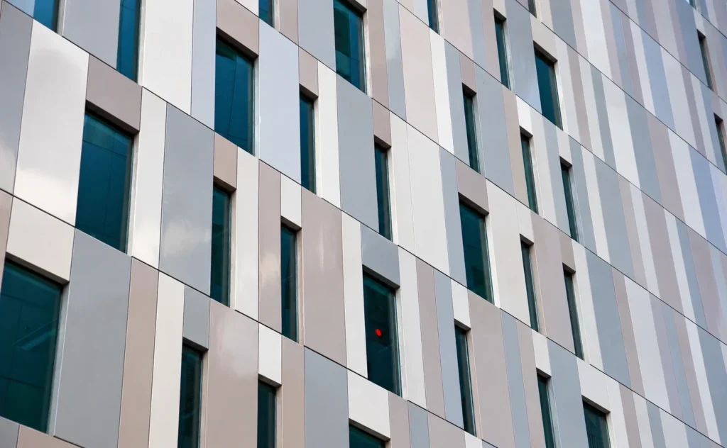 Comparison of faded ACP panels and professionally recoated building facade.