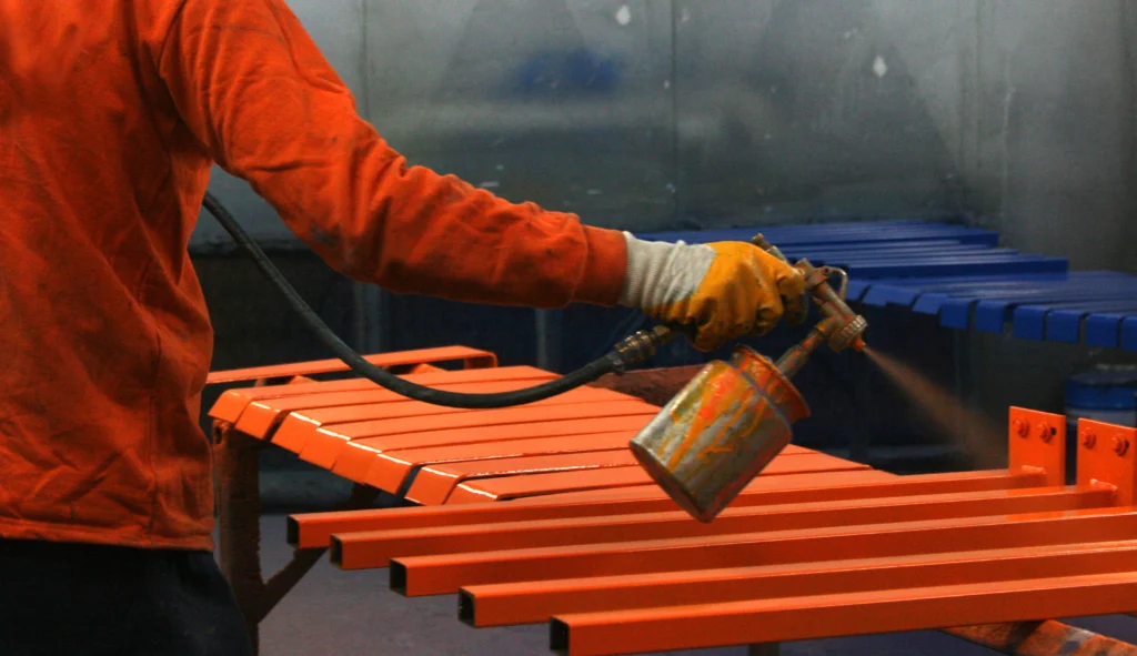 Professional applying protective coating to ACP panels.